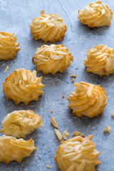Delicious pastry with almond on blue background