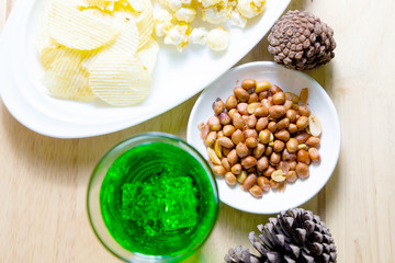 Relax time with juice and snacks on wooden table.