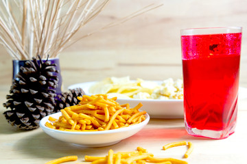 Relax time with juice and snacks on wooden table.