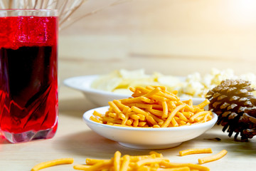 Relax time with juice and snacks on wooden table.