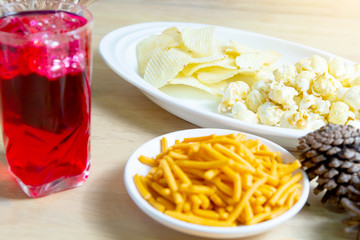 Relax time with juice and snacks on wooden table.