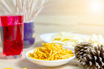 Relax time with juice and snacks on wooden table.
