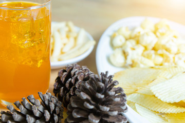 Relax time with juice and snacks on wooden table.