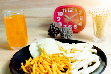 Relax time with juice and snacks on wooden table.