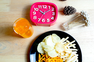 Relax time with juice and snacks on wooden table.