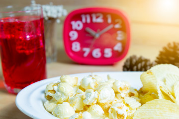 Relax time with juice and snacks on wooden table.