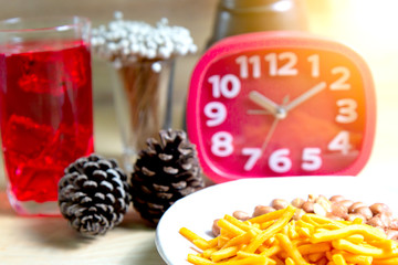 Relax time with juice and snacks on wooden table.