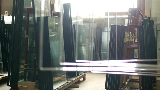 The shop for the production and manufacture of PVC windows, ready-made double-glazed windows stand in the shop for further assembly of PVC windows, insulating
