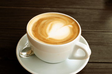 Coffee in white cup on wood table