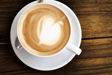 Coffee in white cup on wood table