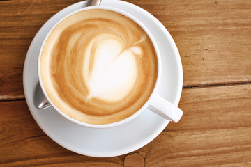 Coffee in white cup on wood table