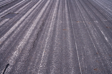 close up of an old airstrip with faded white lines for backgrounds