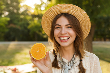 Close up of cheerful young girl in summer hat
