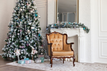 Beautiful modern design of the room in delicate light colors decorated with Christmas tree and decorative elements