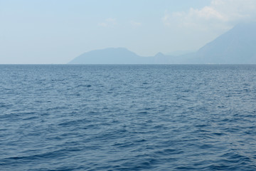 Seascape with the calm sea and an island on horizon (Turkey)