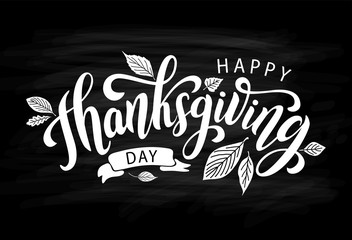 Happy thanksgiving day with autumn leaves. Hand drawn text lettering. Vector illustration. Script. Calligraphic design for print greetings card, shirt, banner, poster. Black chalkboard and white words