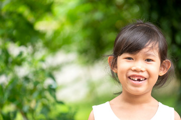 Portrait Asian beautiful girl smiling happy in outdoor park.