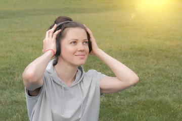 Beautiful caucasian woman in headphones listening to music