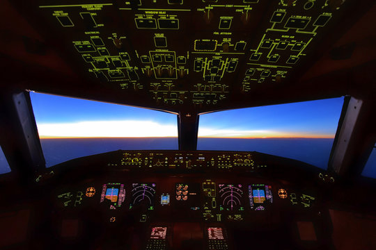 Boeing 777 Cockpit, Flying Over Over Pacific Sea, Pilots Were Performing Their Work During Sunrise Over Japan Airspace.