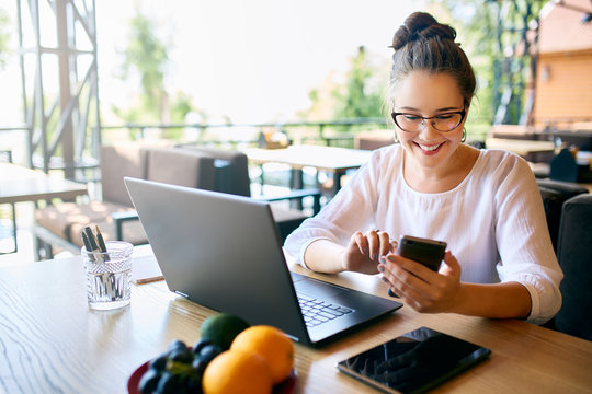 Young Mixed Race Woman Working With Laptop In Cafe At Tropical Location. Asian Caucasian Female Studying Using Internet. Business Woman Doing Social Marketing Work And Shopping. Telecommuting Concept.