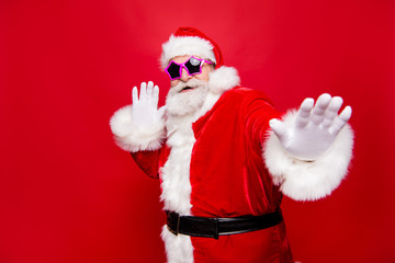 Kind cheerful positive stylish fooling around aged Santa in trad