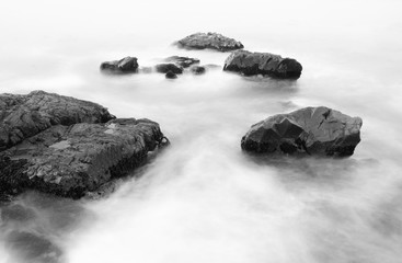 Fototapeta na wymiar Black and white rocks ocean