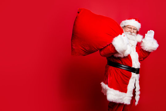 Cheerful nice peaceful Santa in eyeglasses wishes you merry Chri