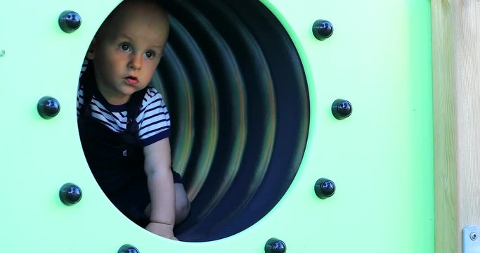 Cute Baby Boy In A Playground Tunnel. Close Up View - DCi 4K Resolution
