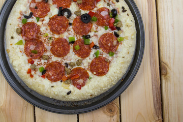 Delicious pepperoni pizza on wooden table.