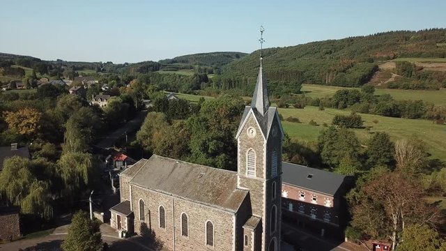 Aerial of a church in a village in the Belgian Ardennes