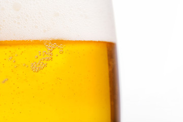 Pouring beer with bubble froth in glass for background. Summer drink, October fest texture