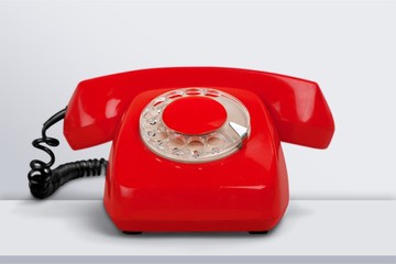 Retro red telephone on background