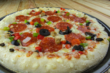 Delicious pepperoni pizza on wooden table.