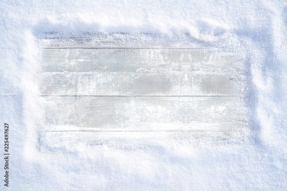 Poster Winter Christmas snowy frame with copy space. Wooden light boards are covered with snow with clean free empty space for text.