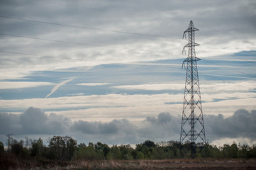 electric metallic pylon by autumn on cloudy sky background