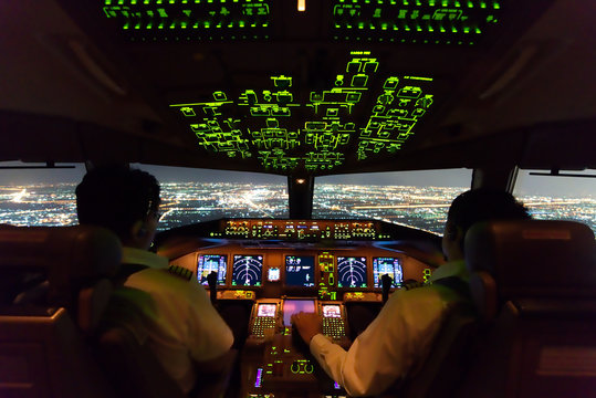 Asian airline pilots were operating commercial aircraft on approach phase over city on the night. Both pilots have to pay special attention on this most critical phase of the flight before landing.
