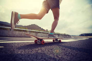 Skateboarder skateboarding on highway road