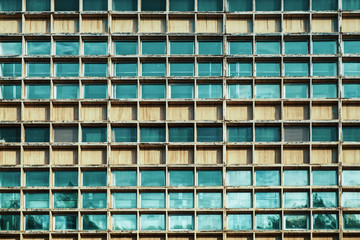 Many windows on facade of high-rise building Abstract pattern.