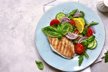 Grilled chicken breast with vegetable salad.Top view with copy space.