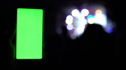 close-up view of modern smartphone on concert festival rock party rave concert lights bokeh blurred background 4k