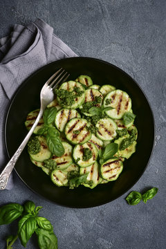 Grilled zucchini slices with pesto sauce.Top view.