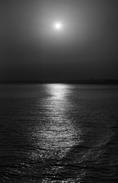 Fototapeta Bosphorus Strait, the panorama of the lighthouse and the surface of the water against the backdrop of the sunset. black and white