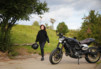 Fototapeta na wymiar Woman and retro cafe racer motorcycle