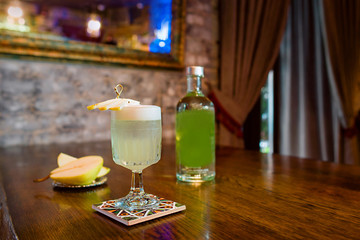 italian pear cocktail with pear and liquor on the table 