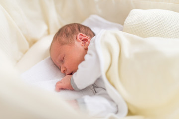 Sweet one month old newborn baby girl is sleeping