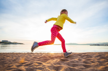  girl running along  sea beach