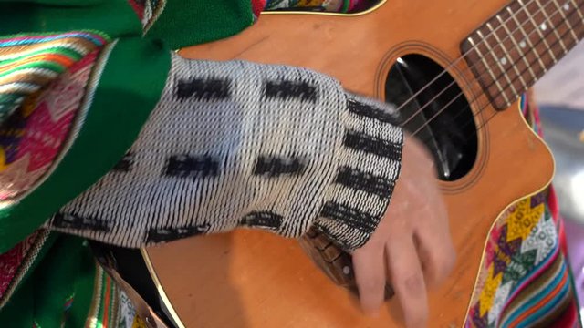 Man in latin clothes playing guitar in the street of Kiev, Ukraine. Guitar and hands close up