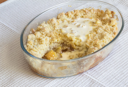Apple crumble in glass dish on white cloth