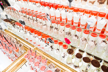 Delicious sweets on wedding candy buffet with desserts, cupcakes