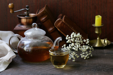 Fototapeta na wymiar kettle with tea on a wooden table rustic still life